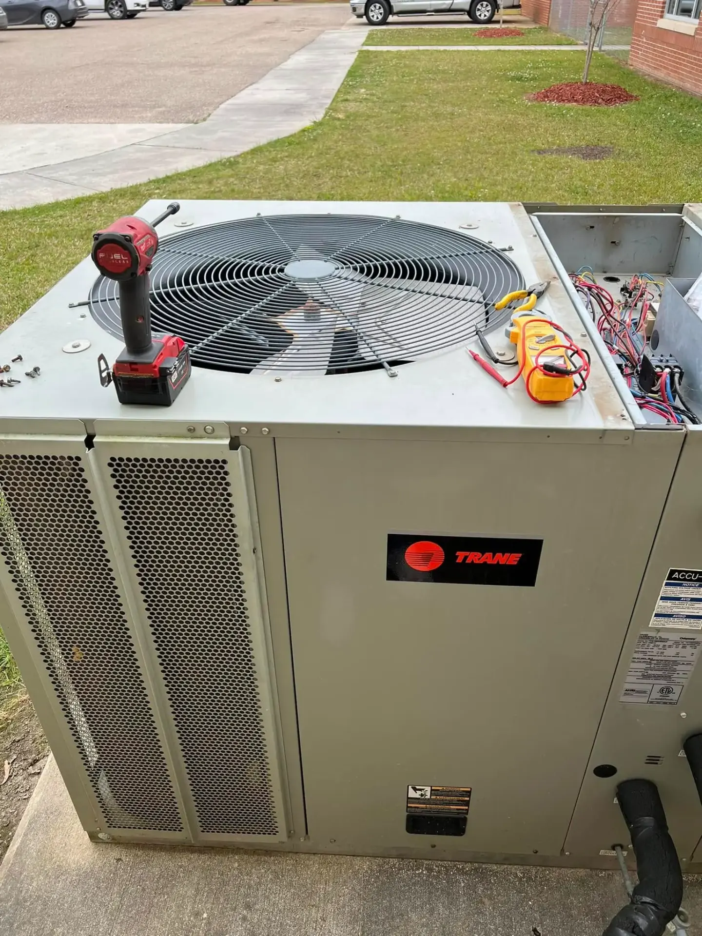 Trane AC unit being serviced with professional tools